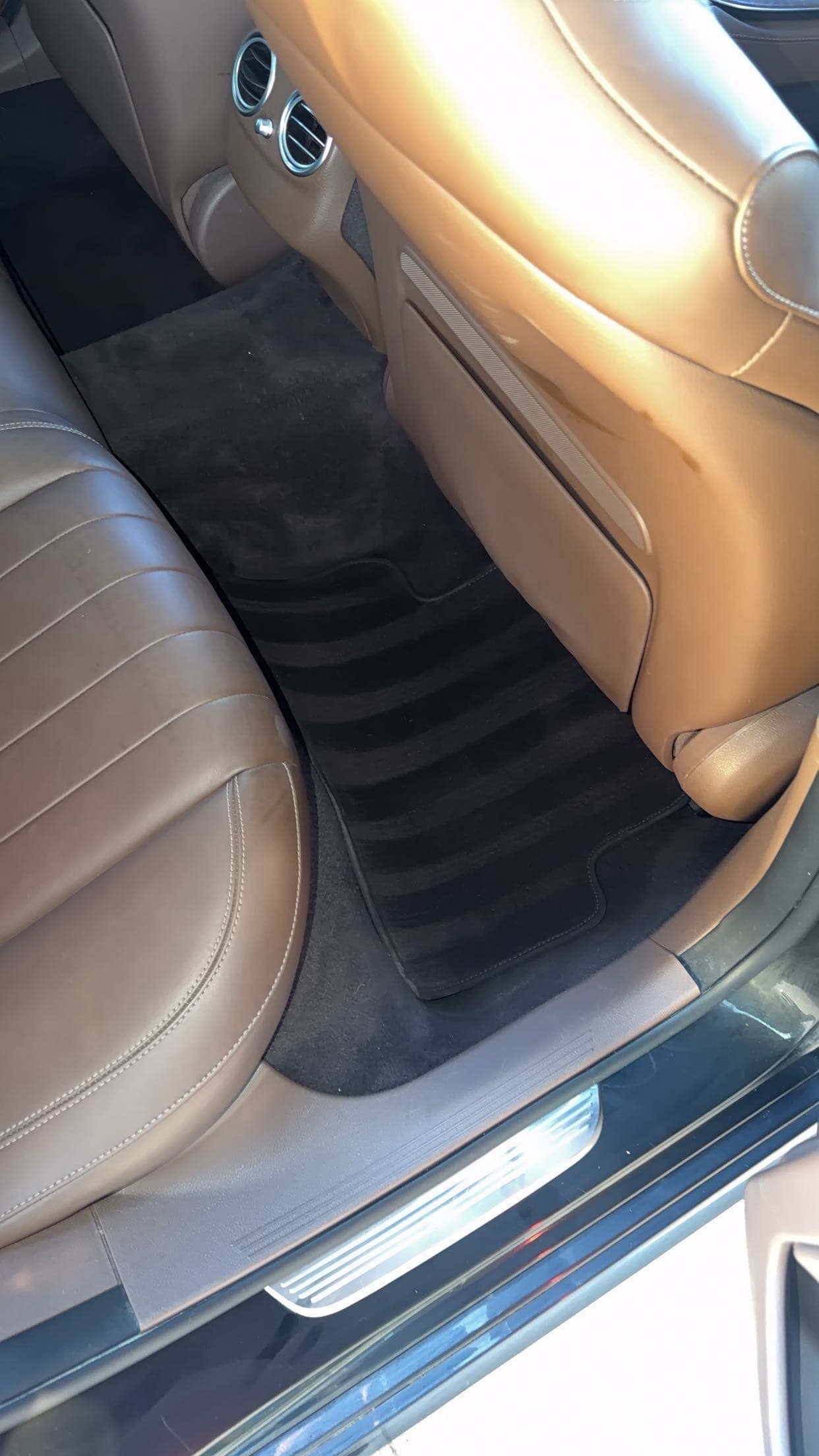 Tan leather rear footwell with cleaned carpet